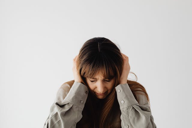 woman sitting with her head down feeling emotions