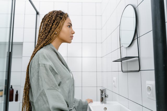 woman looking at herself in a mirror