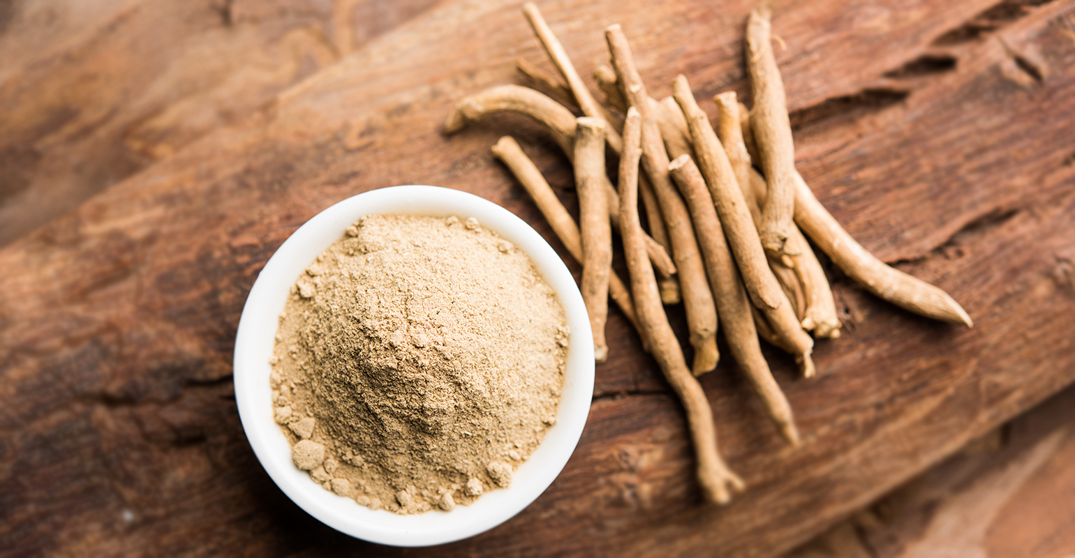 image of ashwagandha root and bowl of ashwagandha powder on a table